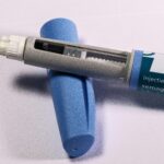 Detailed view of a semaglutide injection pen, commonly used for diabetes treatment, on a plain background.